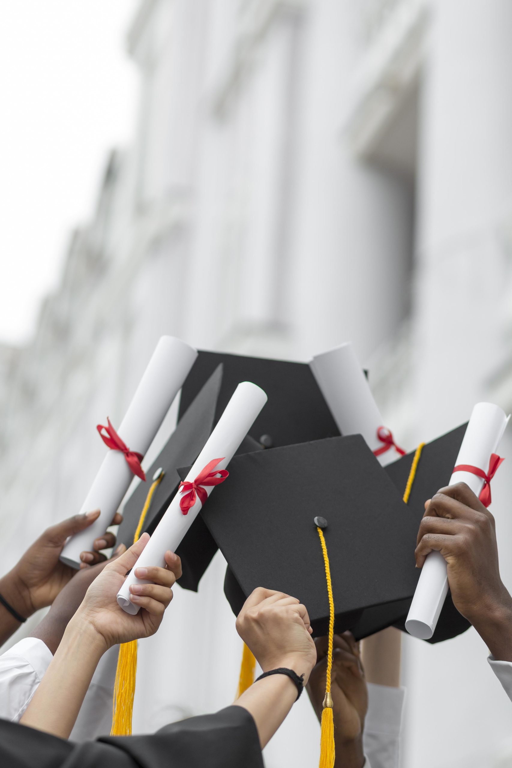 Graduates holding diplomas and caps