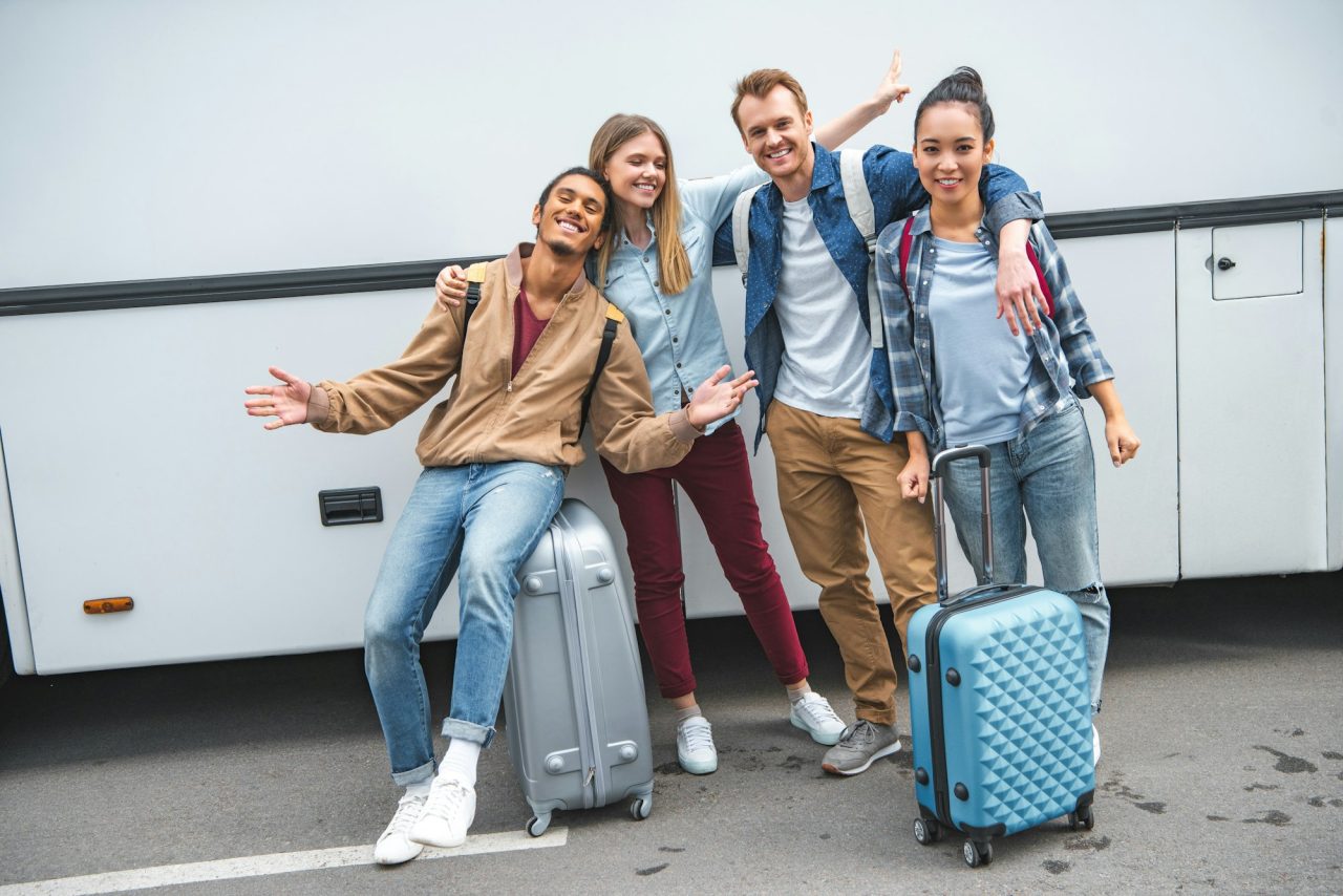 Friends with travel bags setting off on a trip abroad